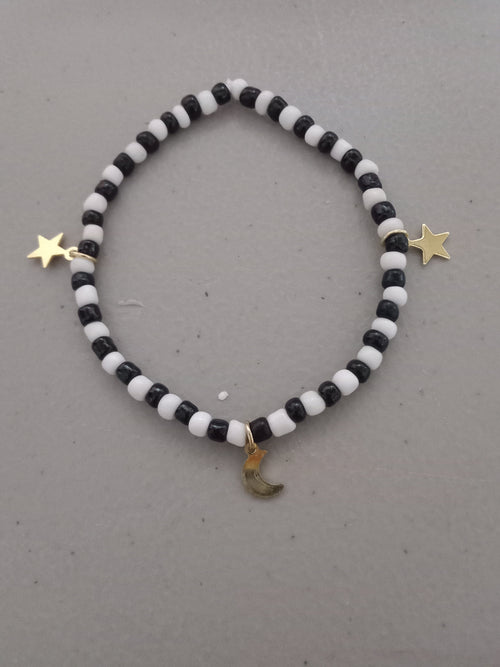 Black and white beaded bracelet with gold star and moon charms